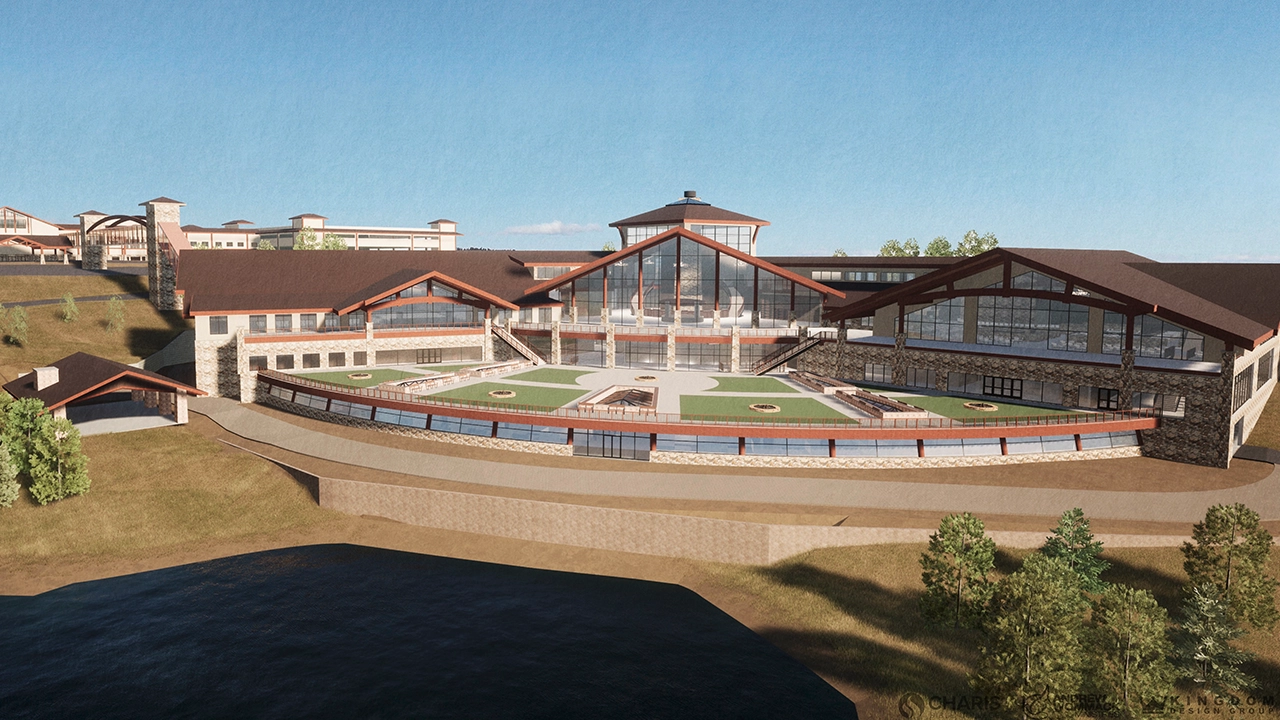 A modern activity center building with large glass windows, stone accents, and tiered outdoor spaces.